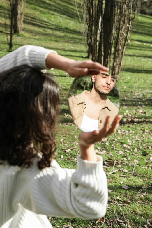 the woman is holding the frisbee above her head