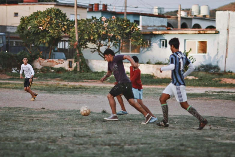 a group of guys playing soccer on a field