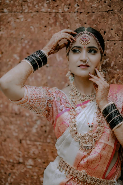 a woman dressed in traditional attire poses for a picture