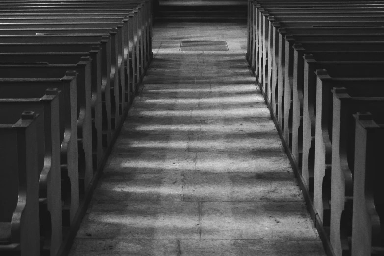 rows of wooden benches lined up in a building