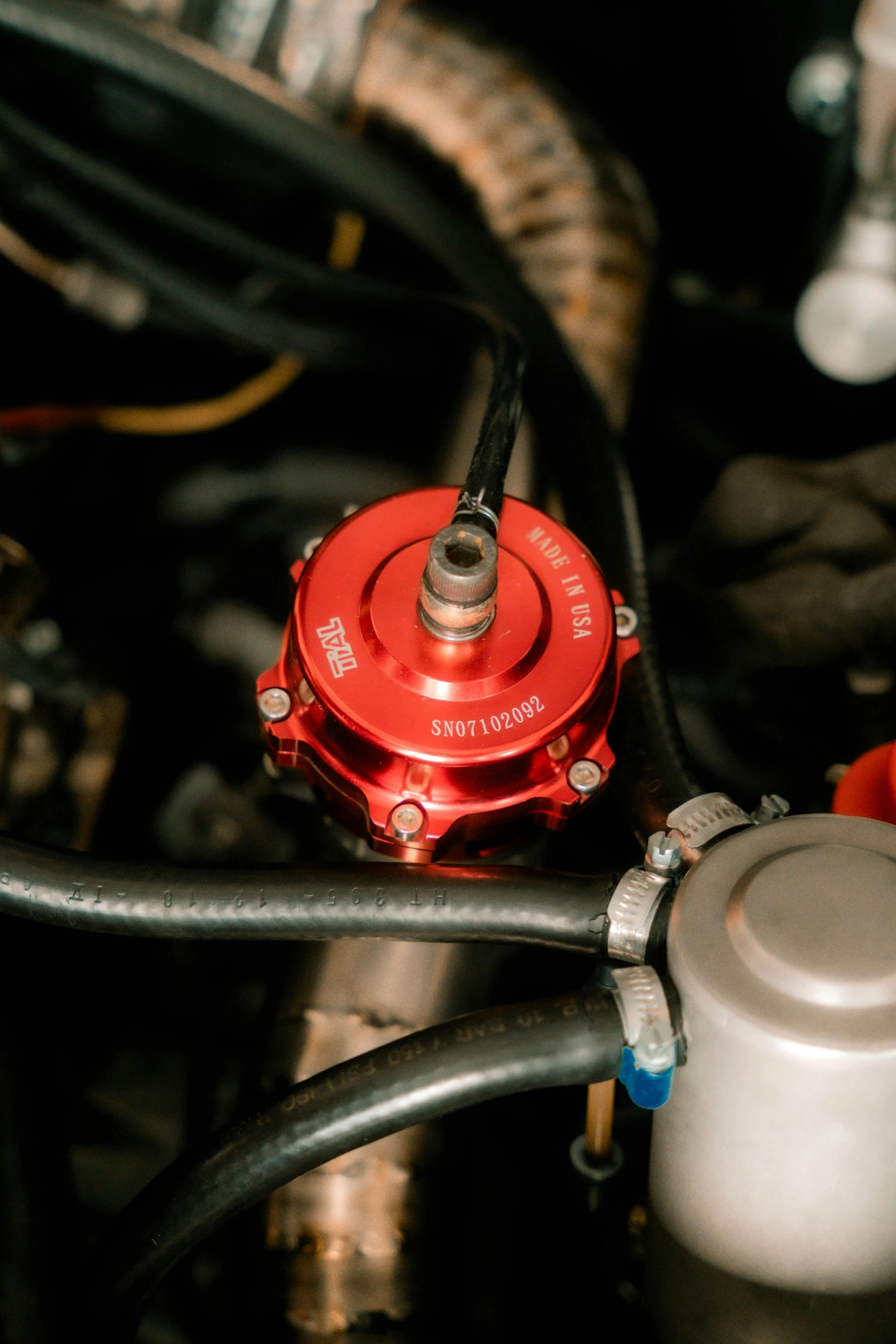 a close - up of an open gas tank with multiple wires attached