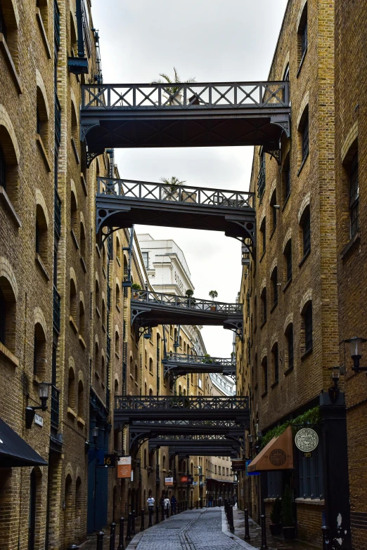 a narrow city street filled with tall brick buildings