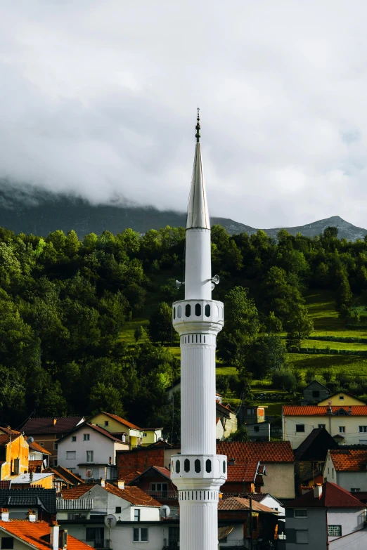 a tall, white tower with a pointed roof