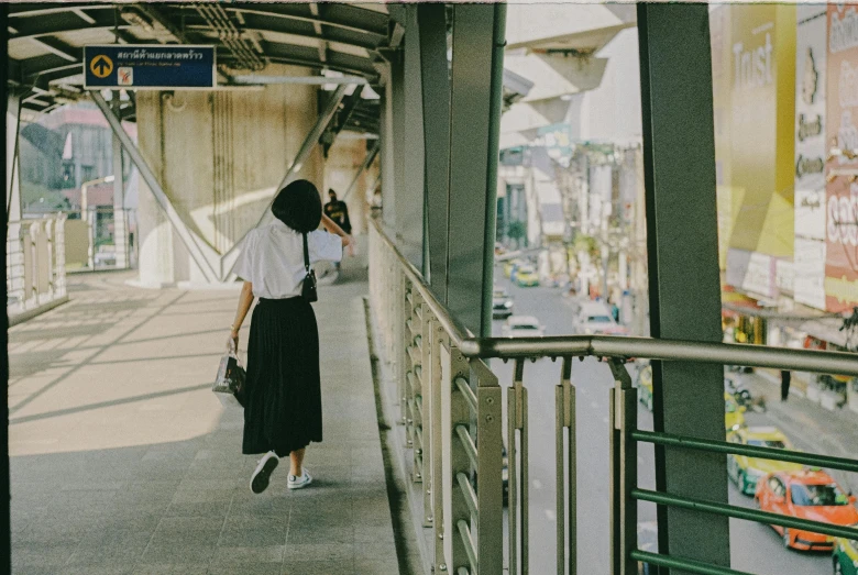 a woman is talking on her cell phone at a bus stop