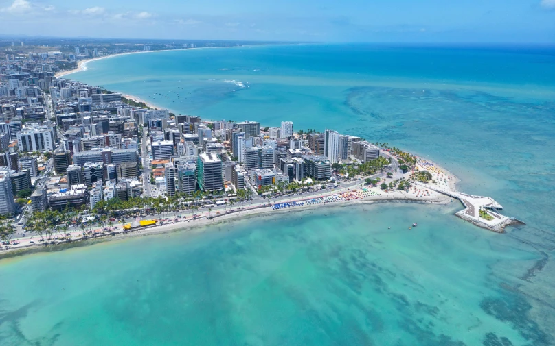 the view from a high - rise area over the ocean shows a tropical city