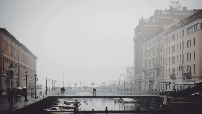 some buildings water a street lights and a few boats