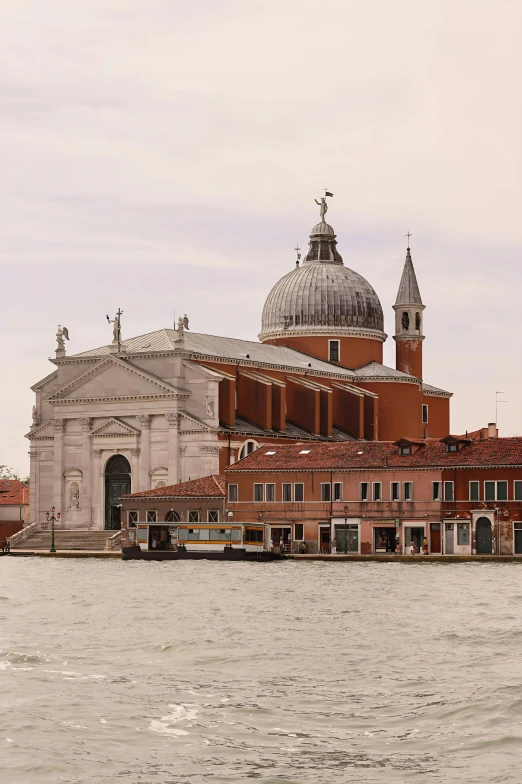 a red building on the side of a large body of water