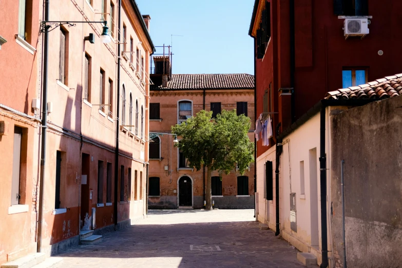 a narrow street with an alley lined by buildings