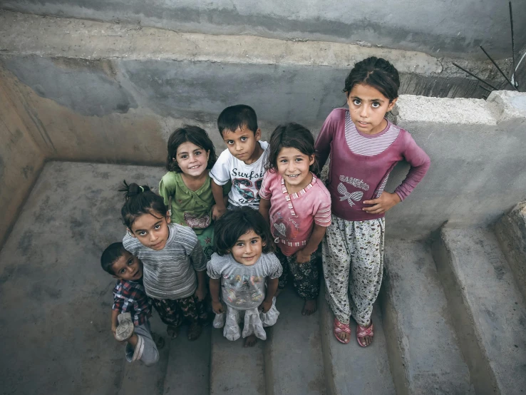 small group of children standing on stairs outside