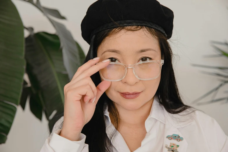 a woman in glasses with a hat on her head