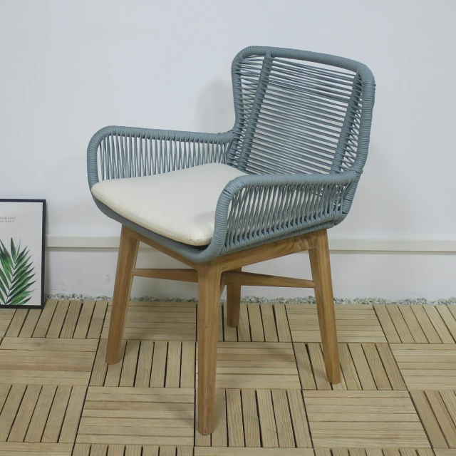 the gray wicker chair has white cushion on it