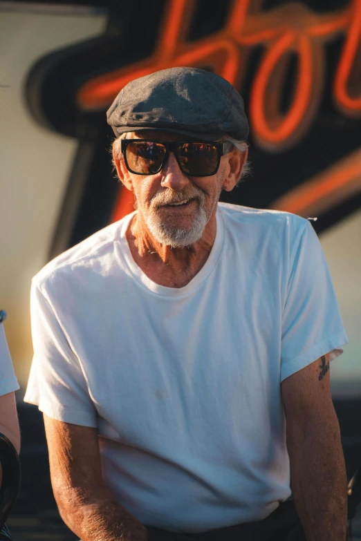 an old man is looking at the camera with a hat on