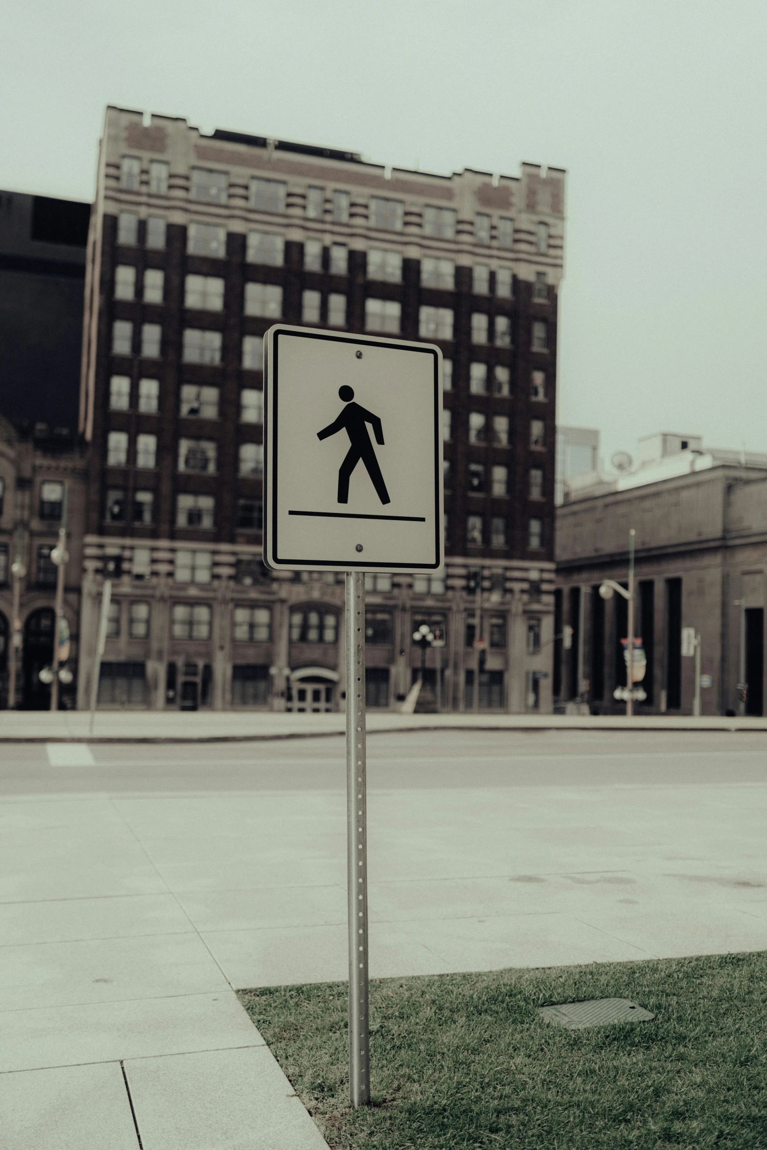 a crosswalk sign in front of a cityscape