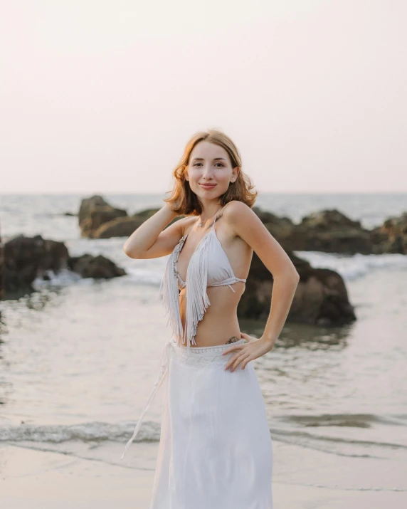 beautiful woman wearing a skirt while standing on the beach