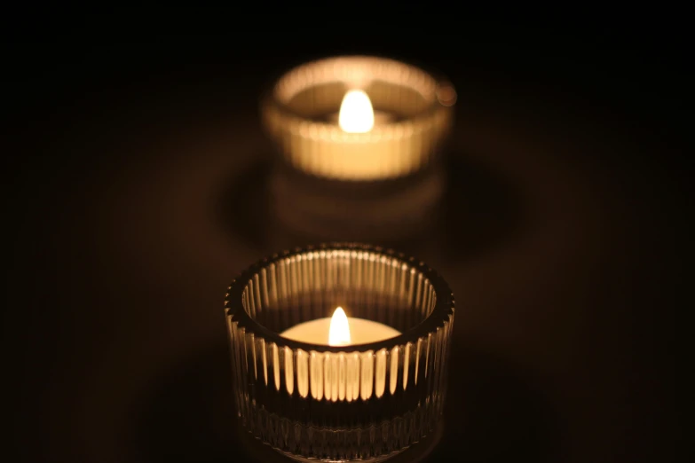 three lit candles sitting on top of a table