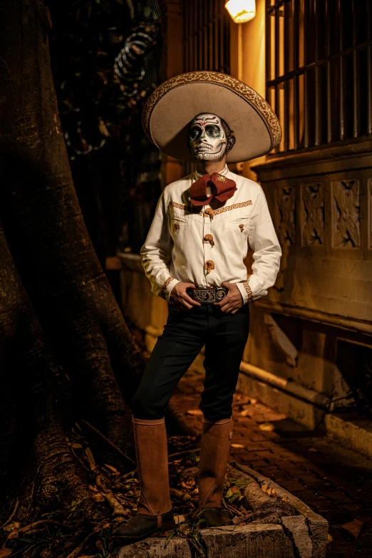 a person in a mexican costume poses for the camera