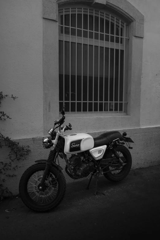 a vintage po of a motorcycle in front of an older building