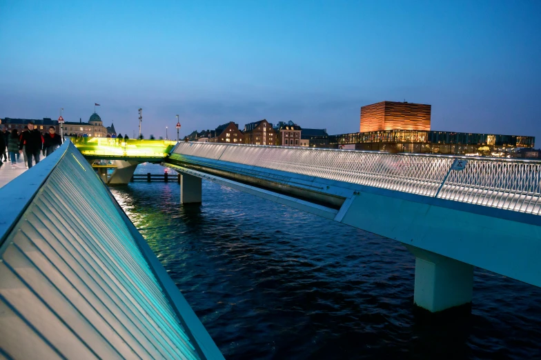 a bridge over water with buildings in the background