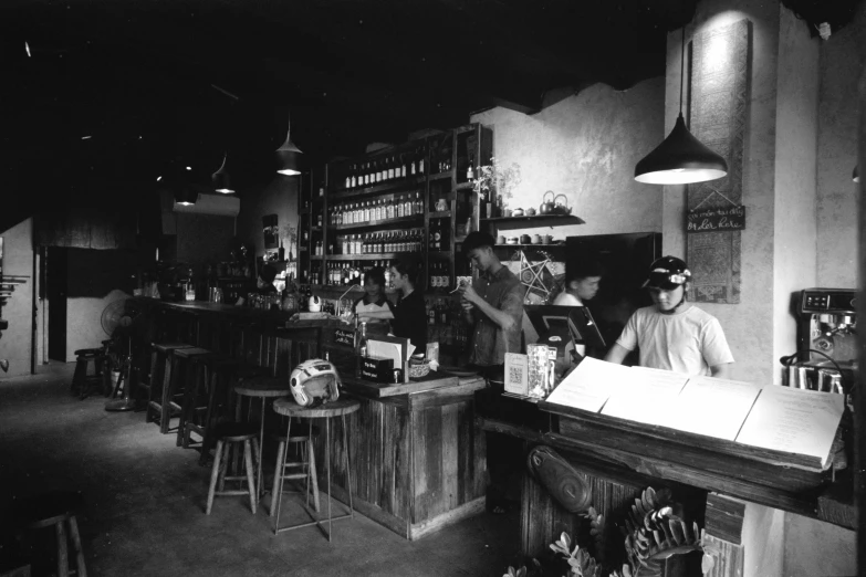 an old black and white po of people in a bar