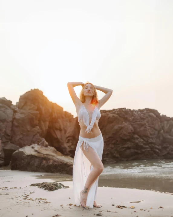 a woman on the beach in a white lace bikini bottom