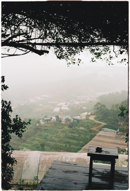 two tables sitting in front of the window overlooking the countryside