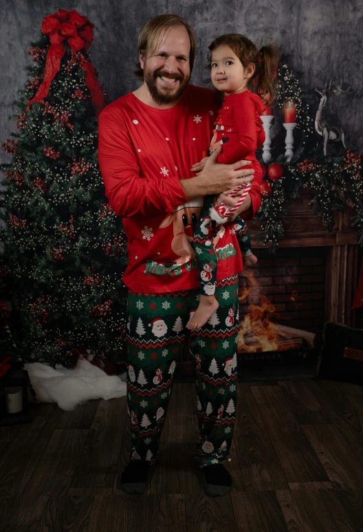 a man and a little girl in matching holiday pajamas