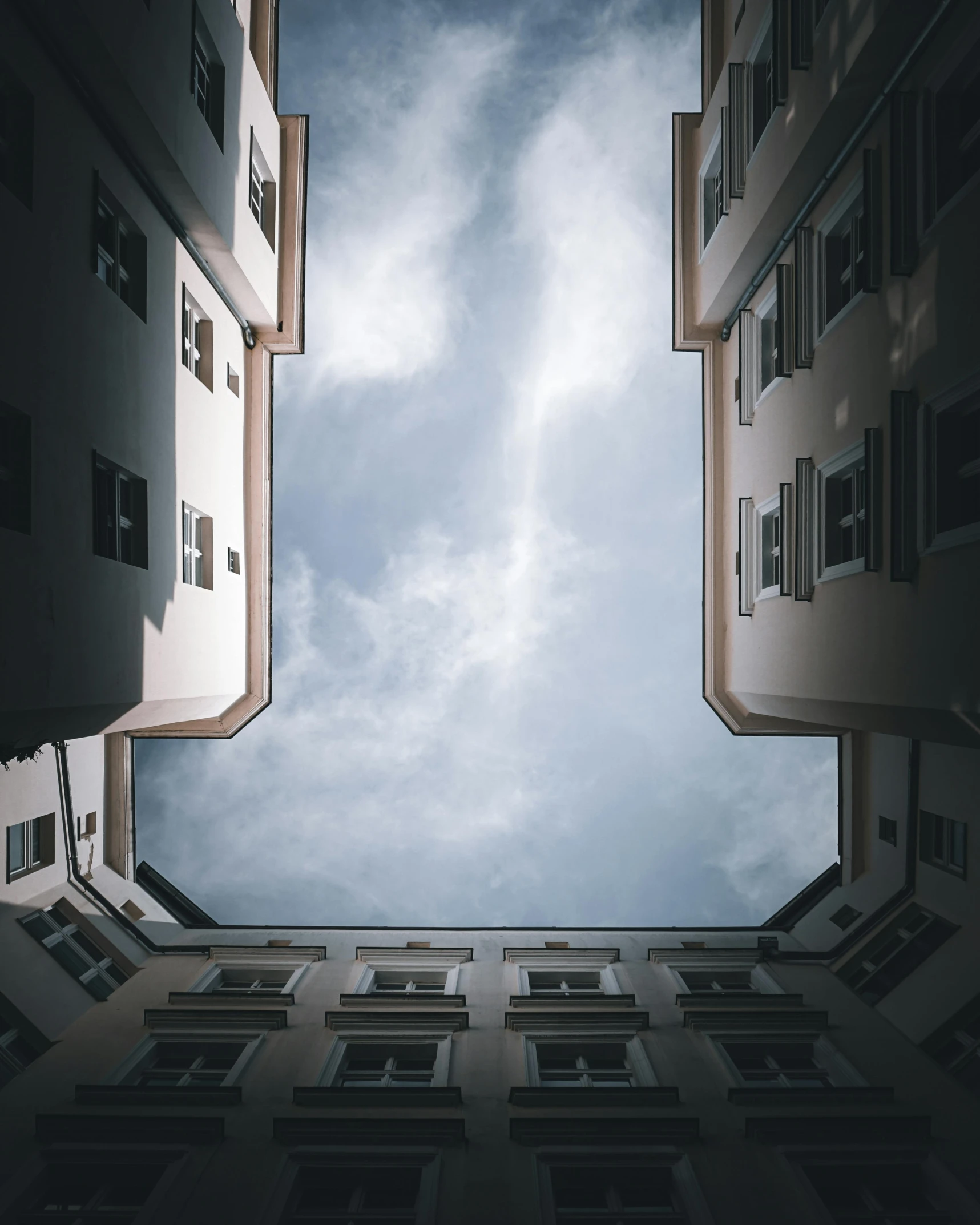 looking up at an upward building's perspective with the sky in the background