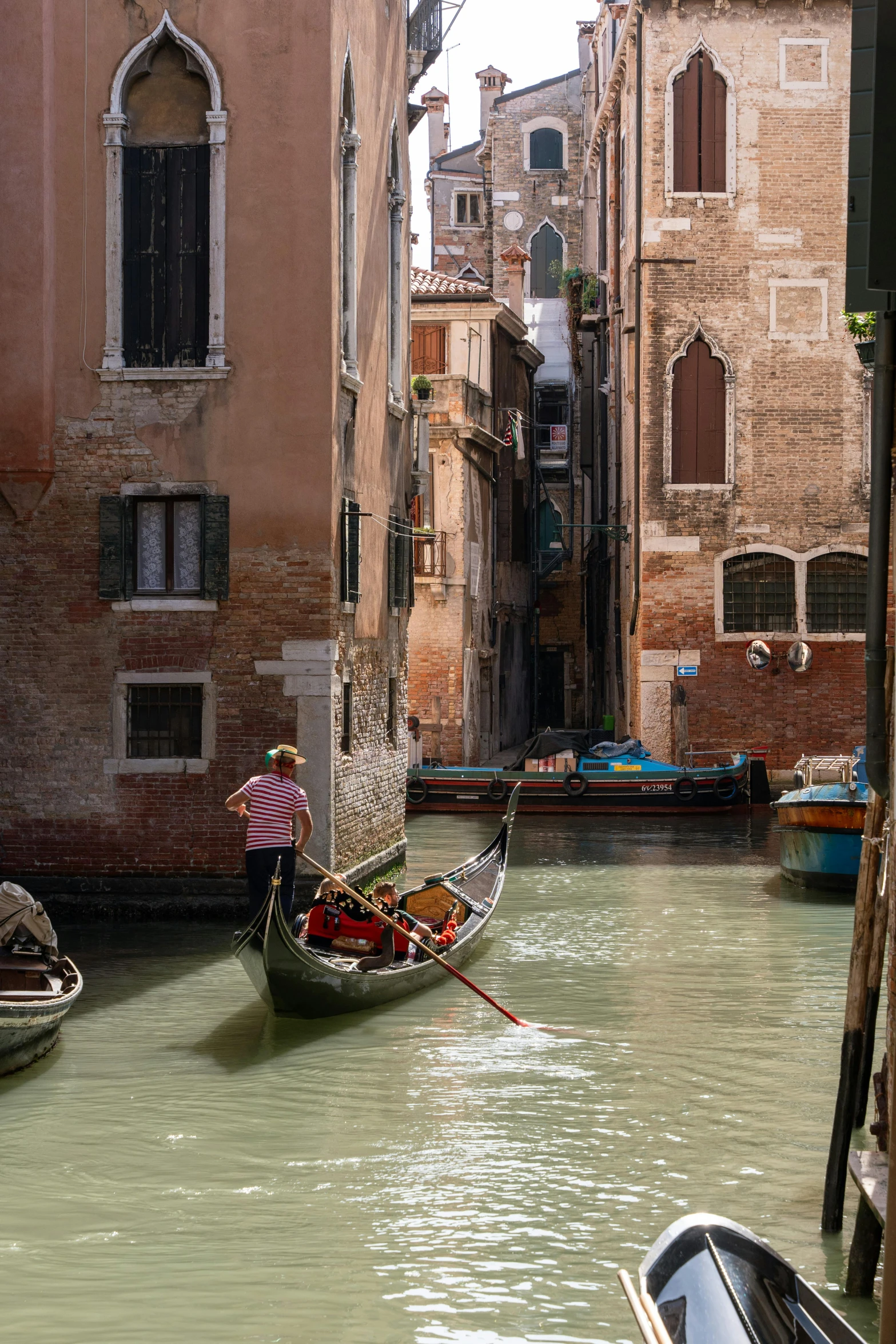 a person riding a boat in an old canal