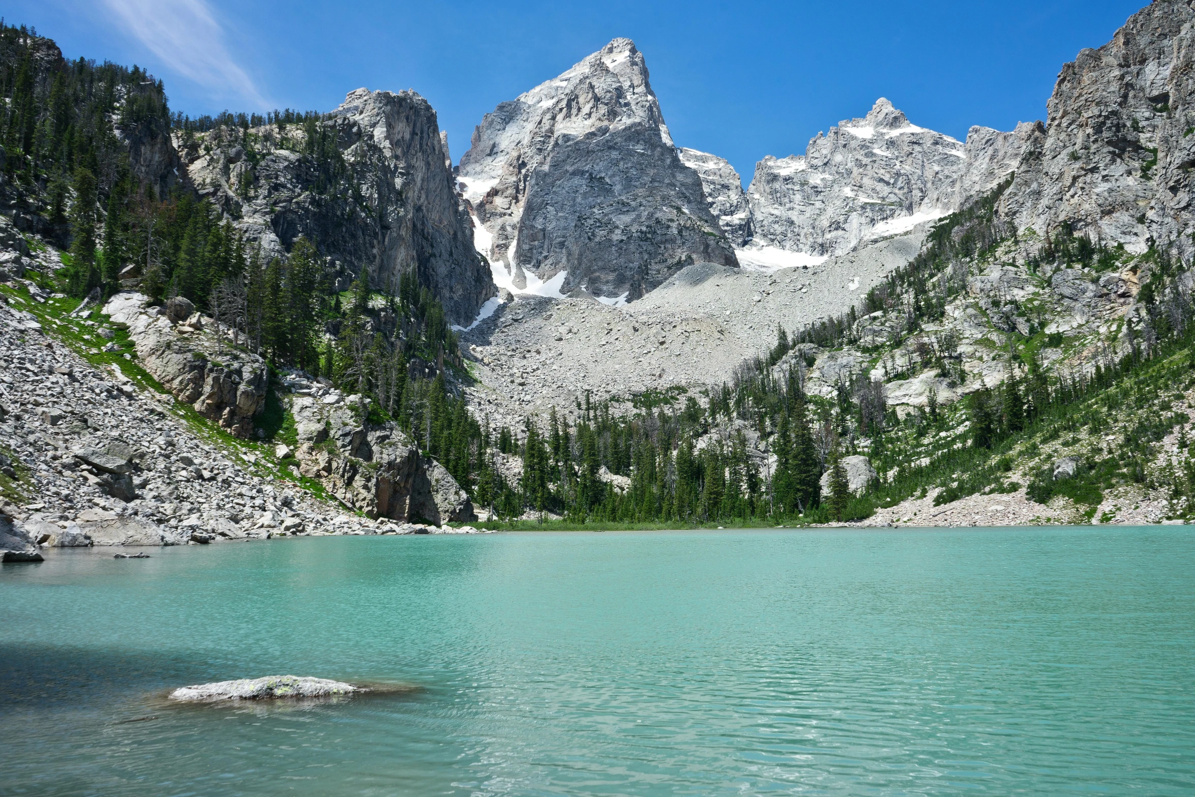 a mountain lake surrounded by lush green trees