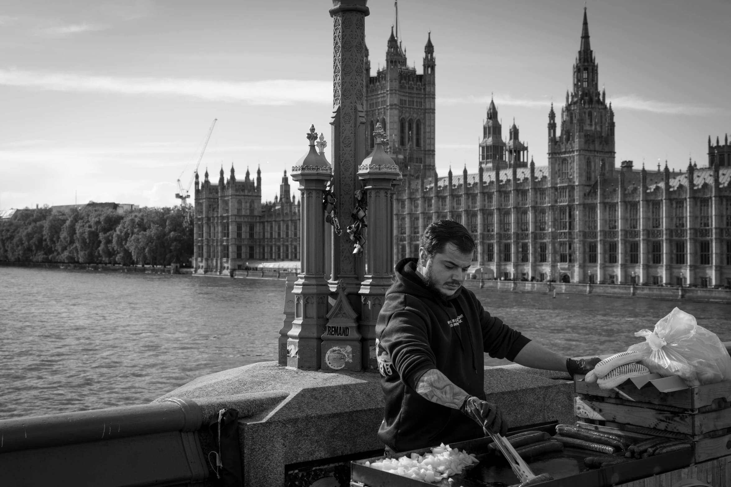 a person standing near water with lots of buildings in the background