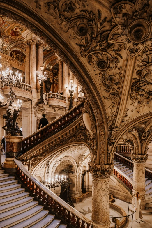 an ornate staircase and chandelier in a large building