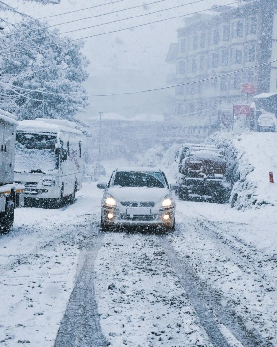 the cars are parked on the road covered in snow