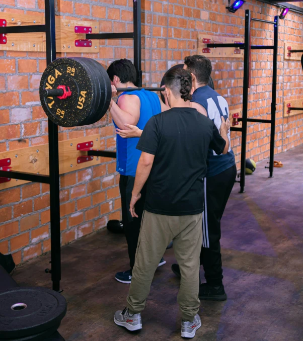 several people are performing an obstacle in a gym