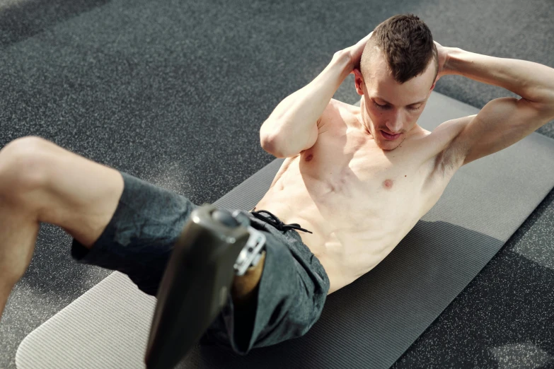 a young man doing h ups on a rug