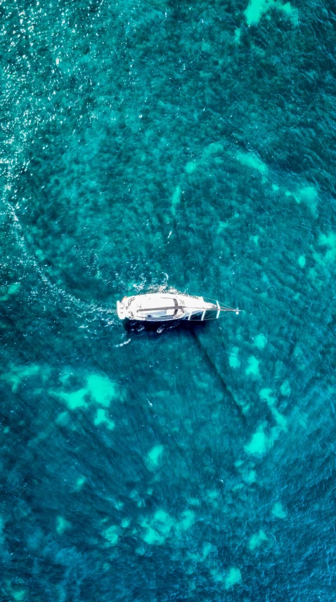 a boat floating in a body of blue water