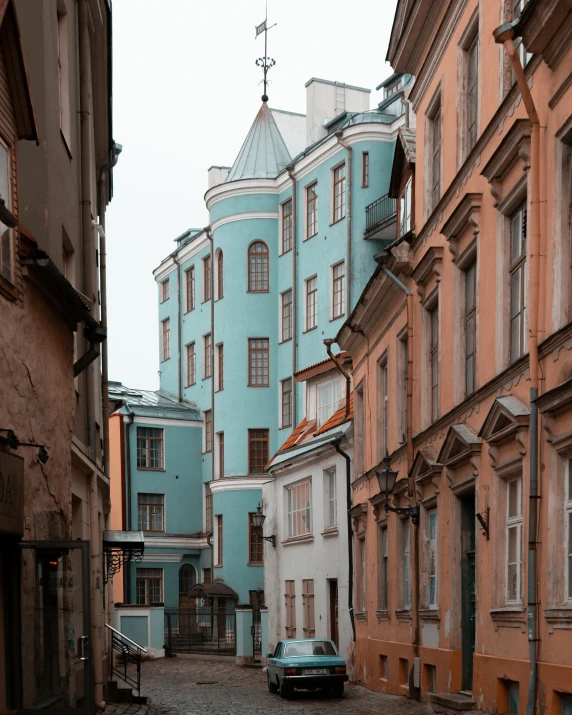 a cobblestone street in old city with several houses