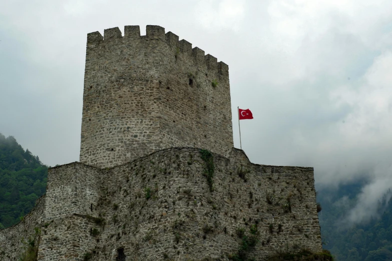 a large stone castle on top of a rocky hillside