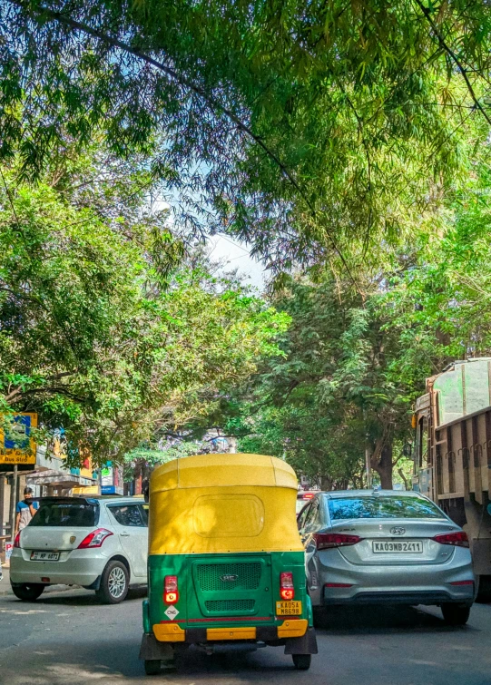 a green and yellow car and two vehicles