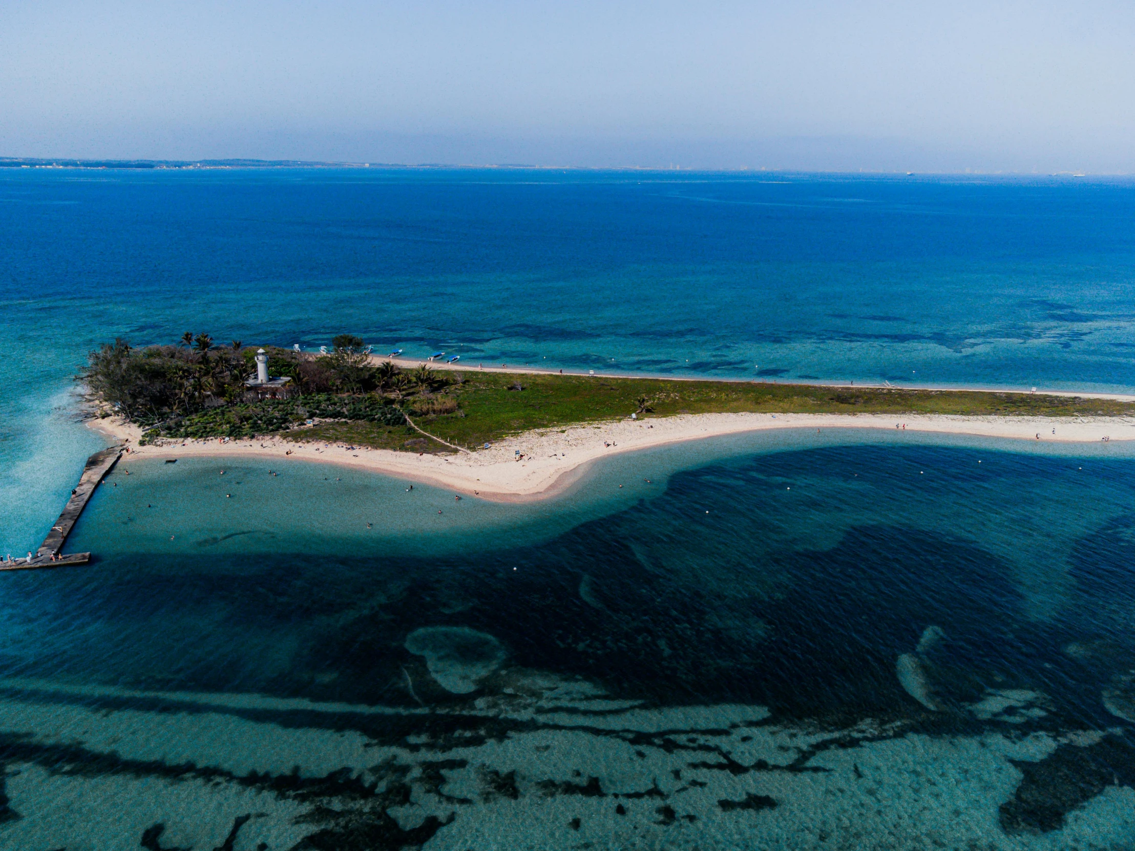 an island with a pier in the middle surrounded by water