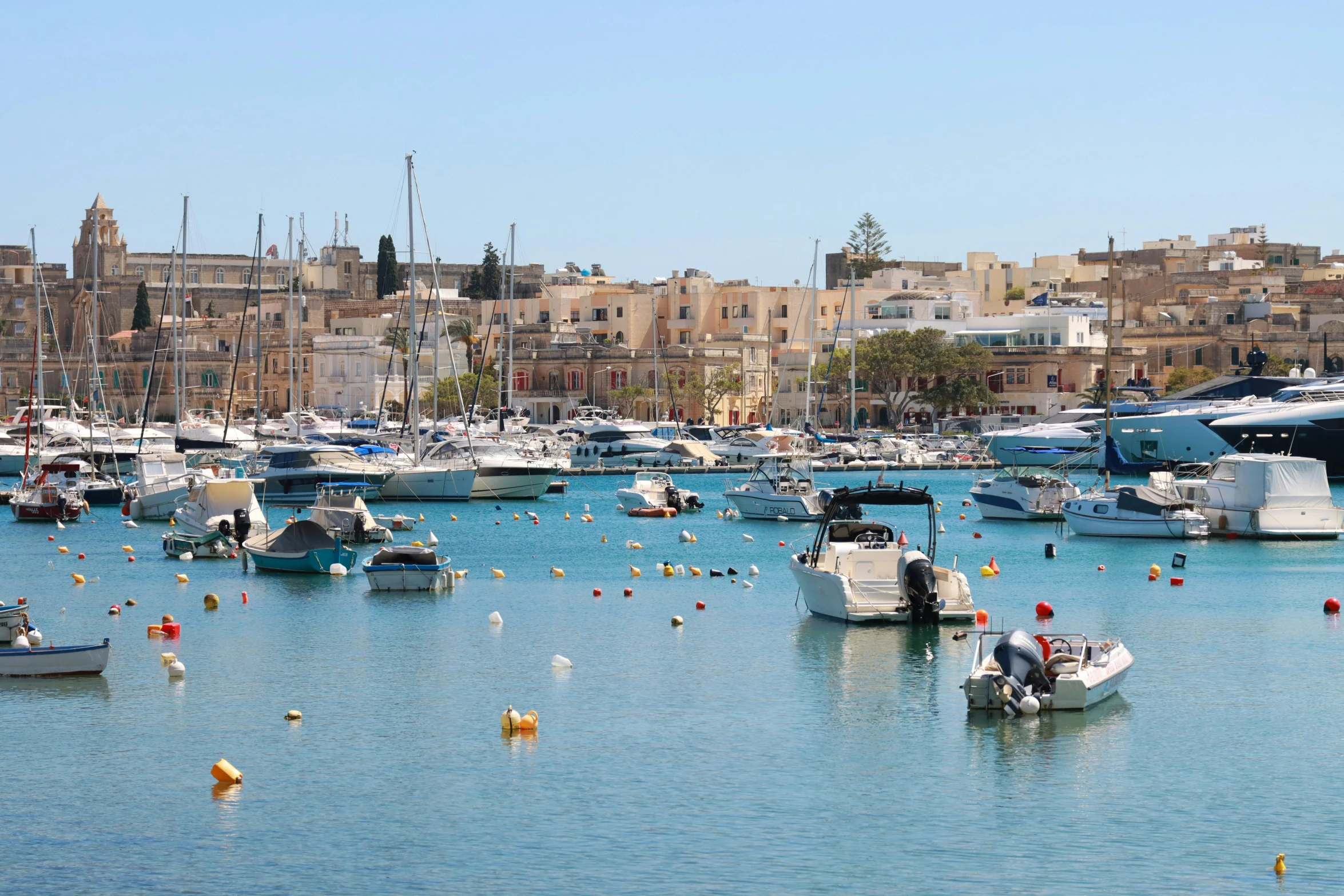 several boats in the water near some buildings