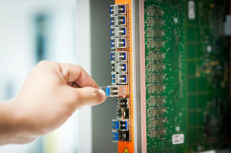 an electrical technician repairing an industrial circuit board