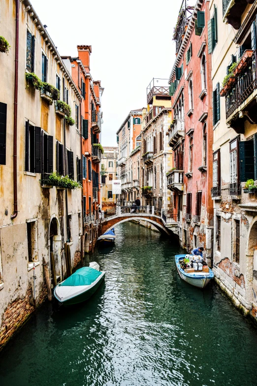 the canal in venice has a few boats in it