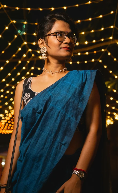 a woman is wearing glasses standing outside