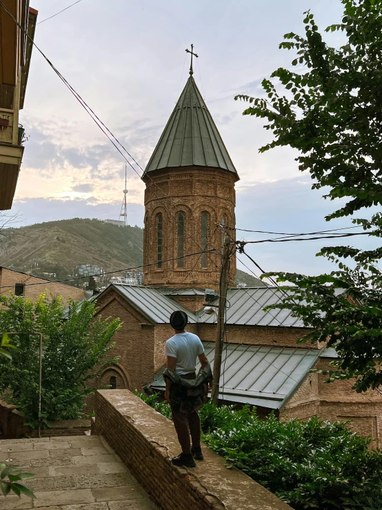 a person looking down on some steps in front of a church