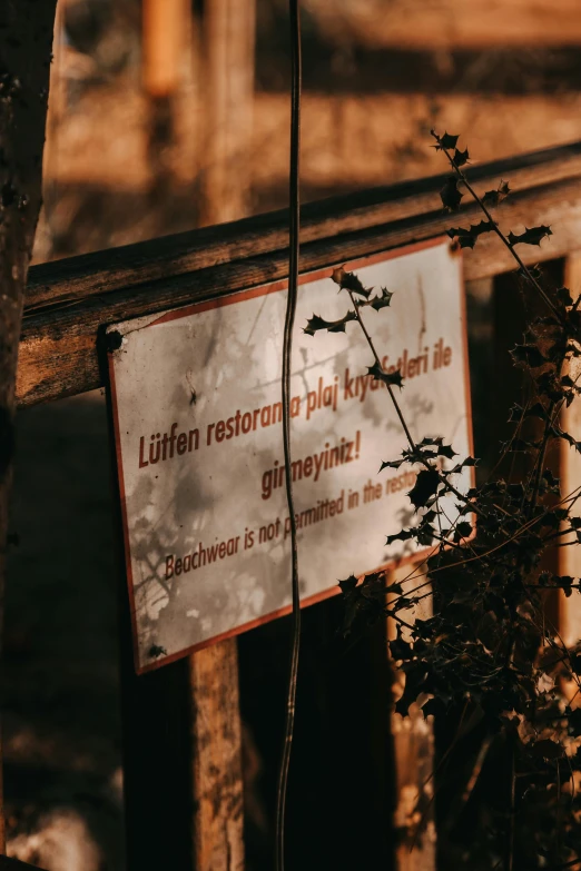 a sign is posted on a fence post