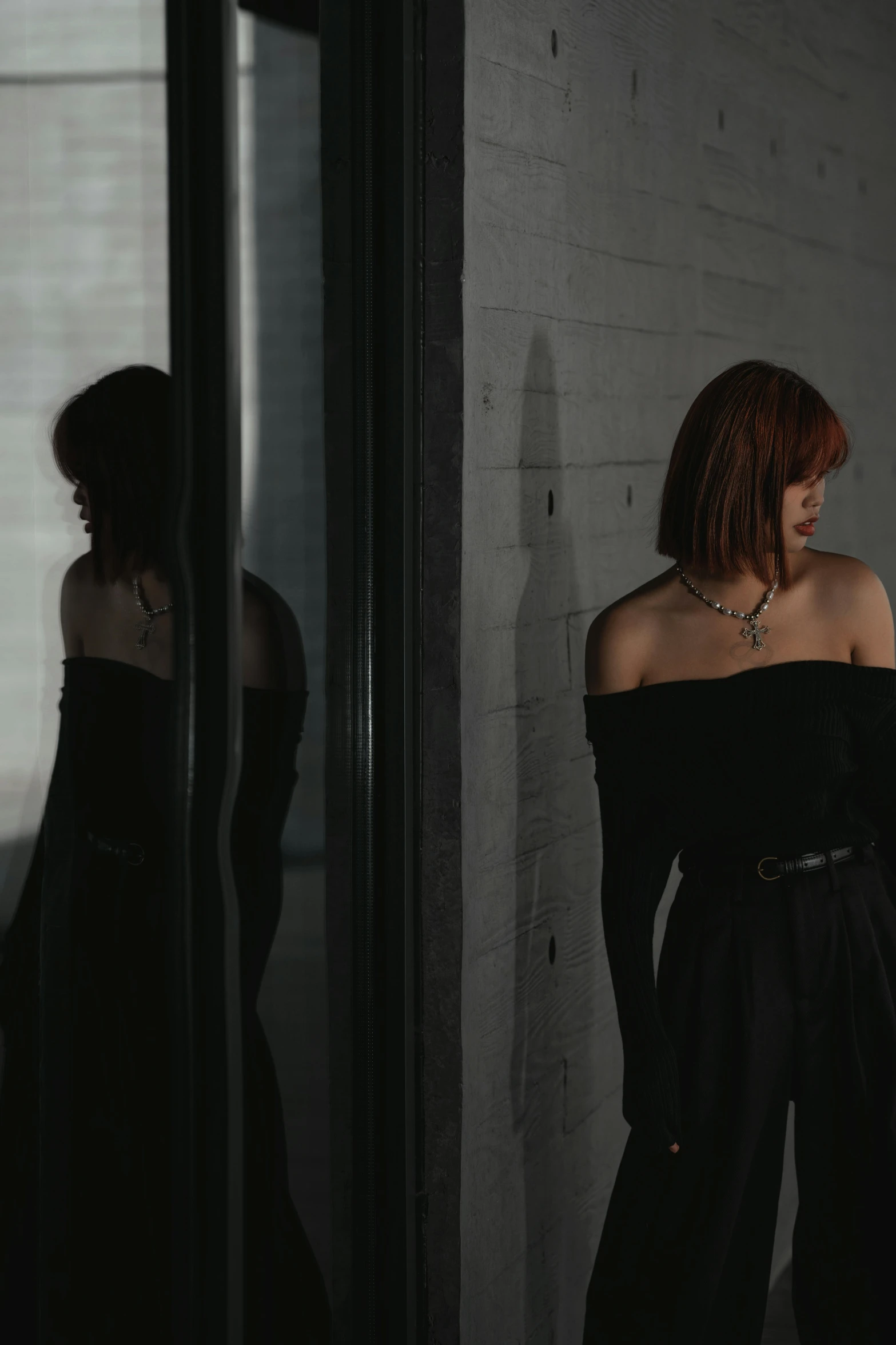 the back of a woman's head wearing a black evening gown