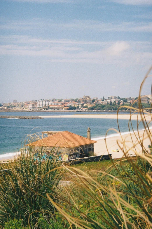 a hut is seen on the edge of an ocean with many buildings on it