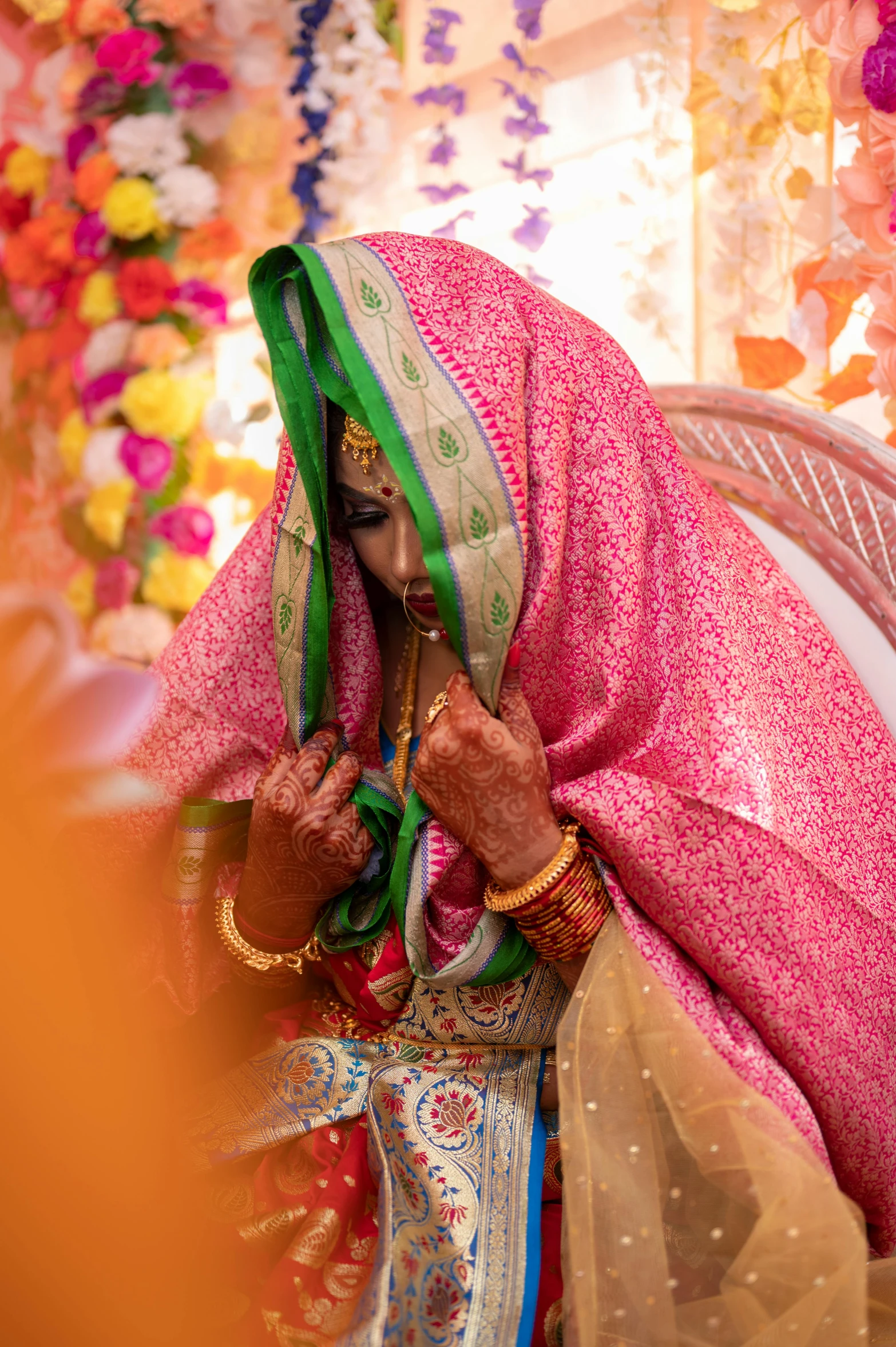 woman in bright colorful outfit sitting down and looking at phone