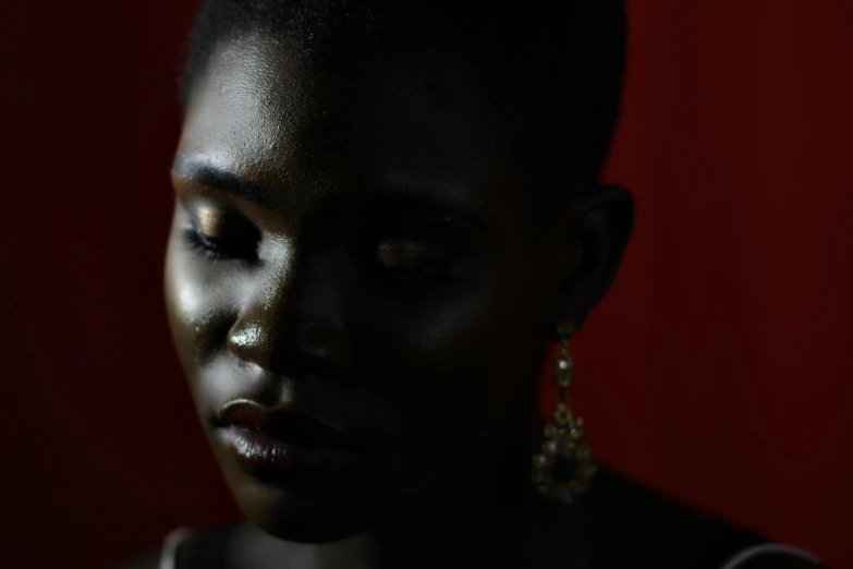 close up s of a black woman with big earrings on her face