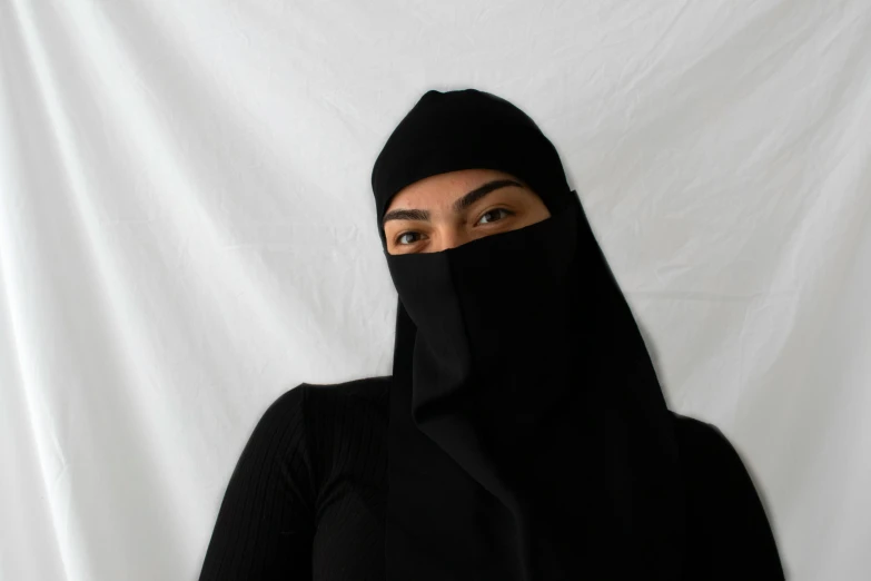 a woman in a black head covering over her face